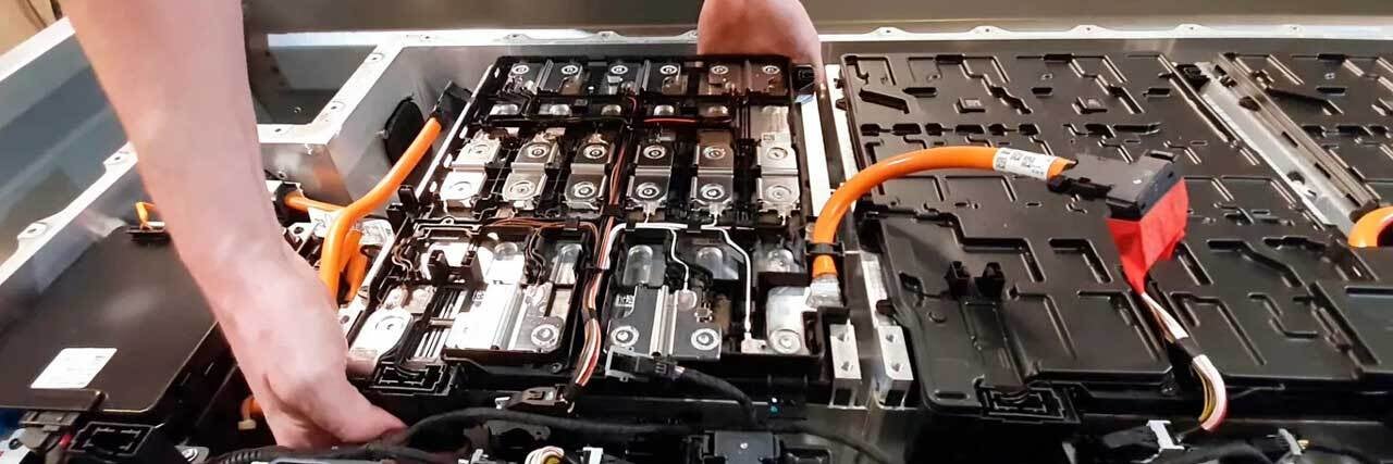 close up view of electric vehicle battery getting serviced